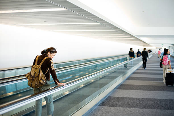people travelling in airport escalators