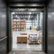 Cargo lift dealer in Lahore: heavy-duty freight elevator loaded with pallets in a warehouse